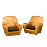 A pair of Mid Century faux leather armchairs with teak padded arms. 1970’s.