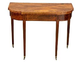 An Early 19th Century George III Sheraton style inlaid mahogany turnover tea table. Circa 1800.