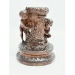 A 19th Century glazed ceramic cherub candleholder. 13x15cm