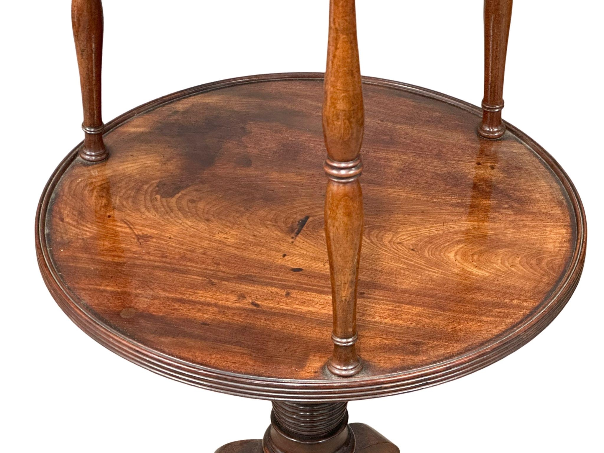 A George III mahogany revolving pedestal dumbwaiter with reeded column and brass cup casters, - Image 4 of 4