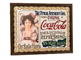 A Coca-Cola advertising mirror. 64x50cm