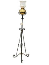 An early 20th century wrought iron floor lamp with brass bowl. 160cm