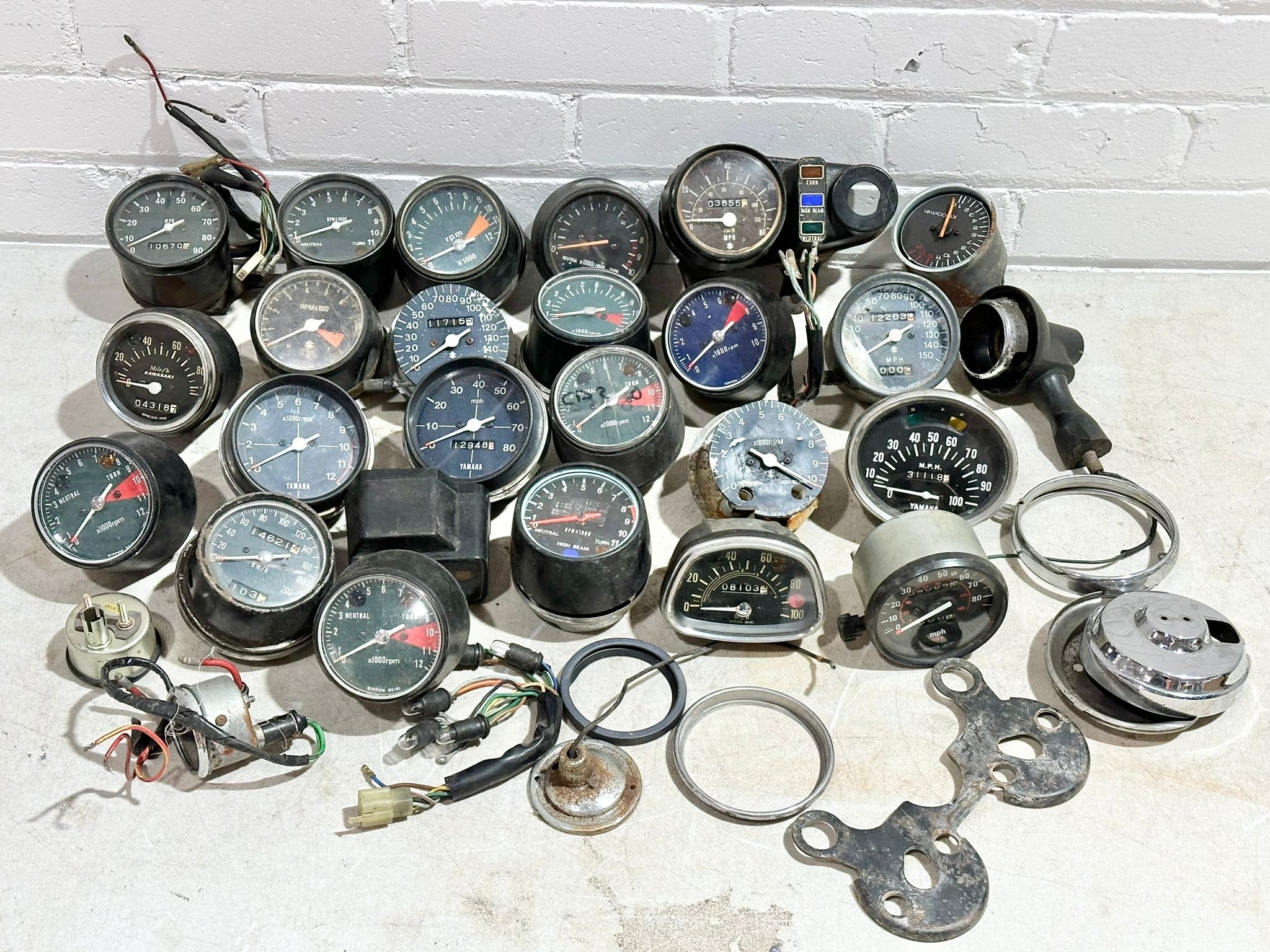 A quantity of various vintage motorbike clocks