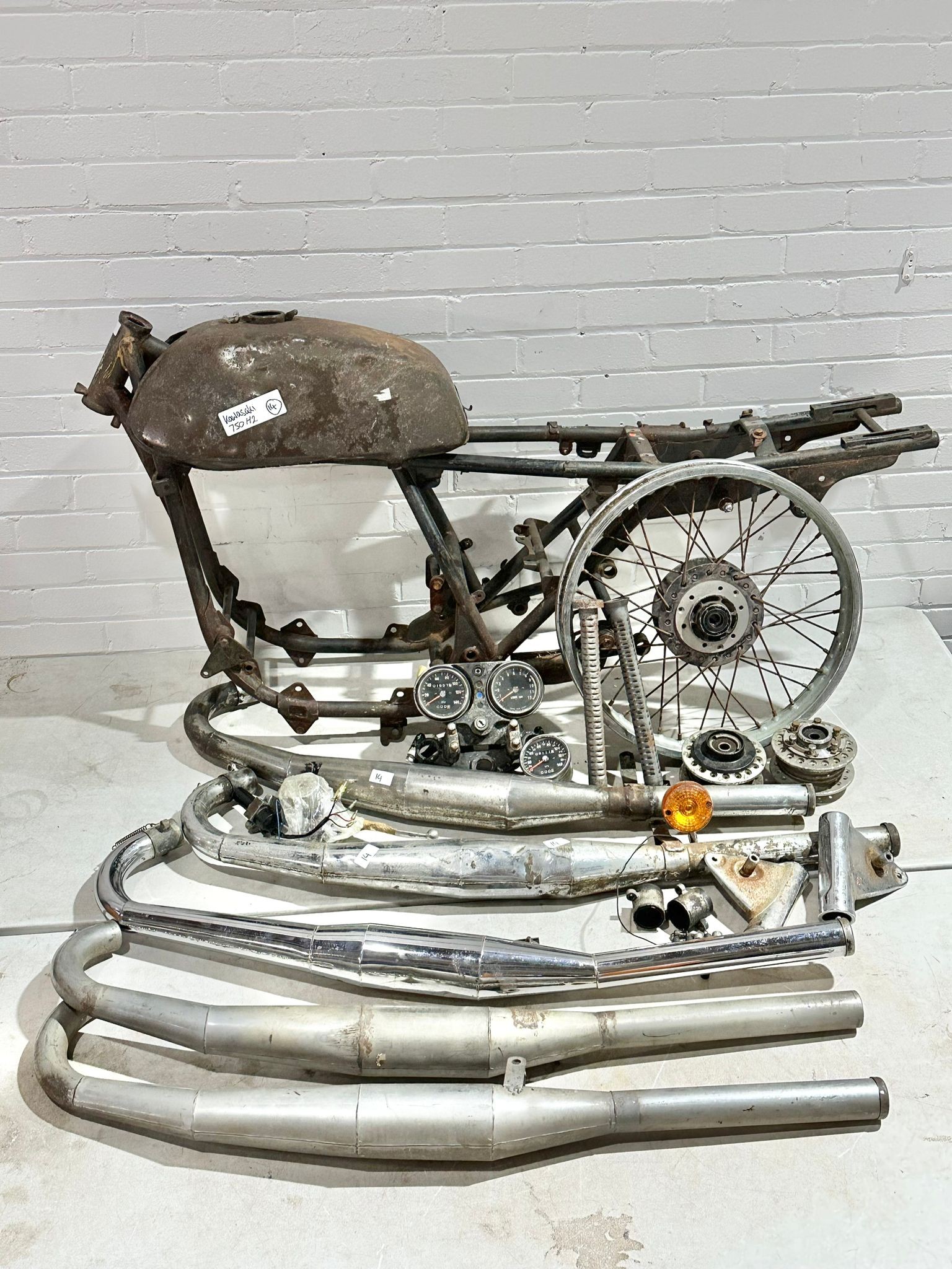 A Kawasaki 750 H2 Widow Maker Frame 1974/5, with exhausts, tank and other various parts.