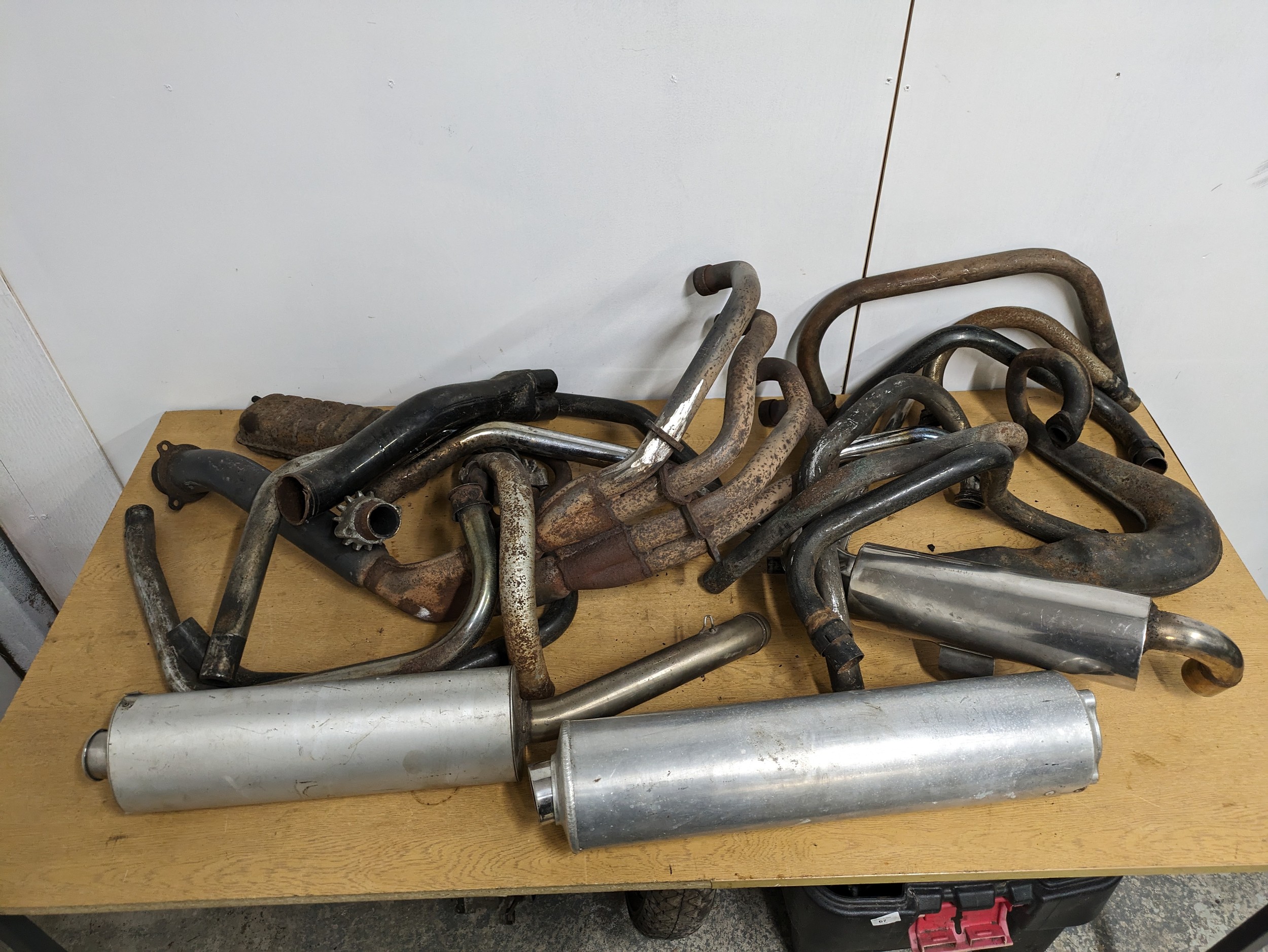 A quantity of assorted motorbike exhausts, including Ducati