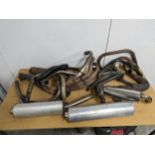 A quantity of assorted motorbike exhausts, including Ducati