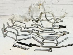 A quantity of various motorbike handlebars