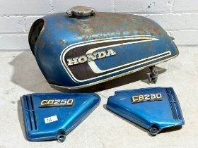 A pair of Honda CB250 G5 side panels with matching tank