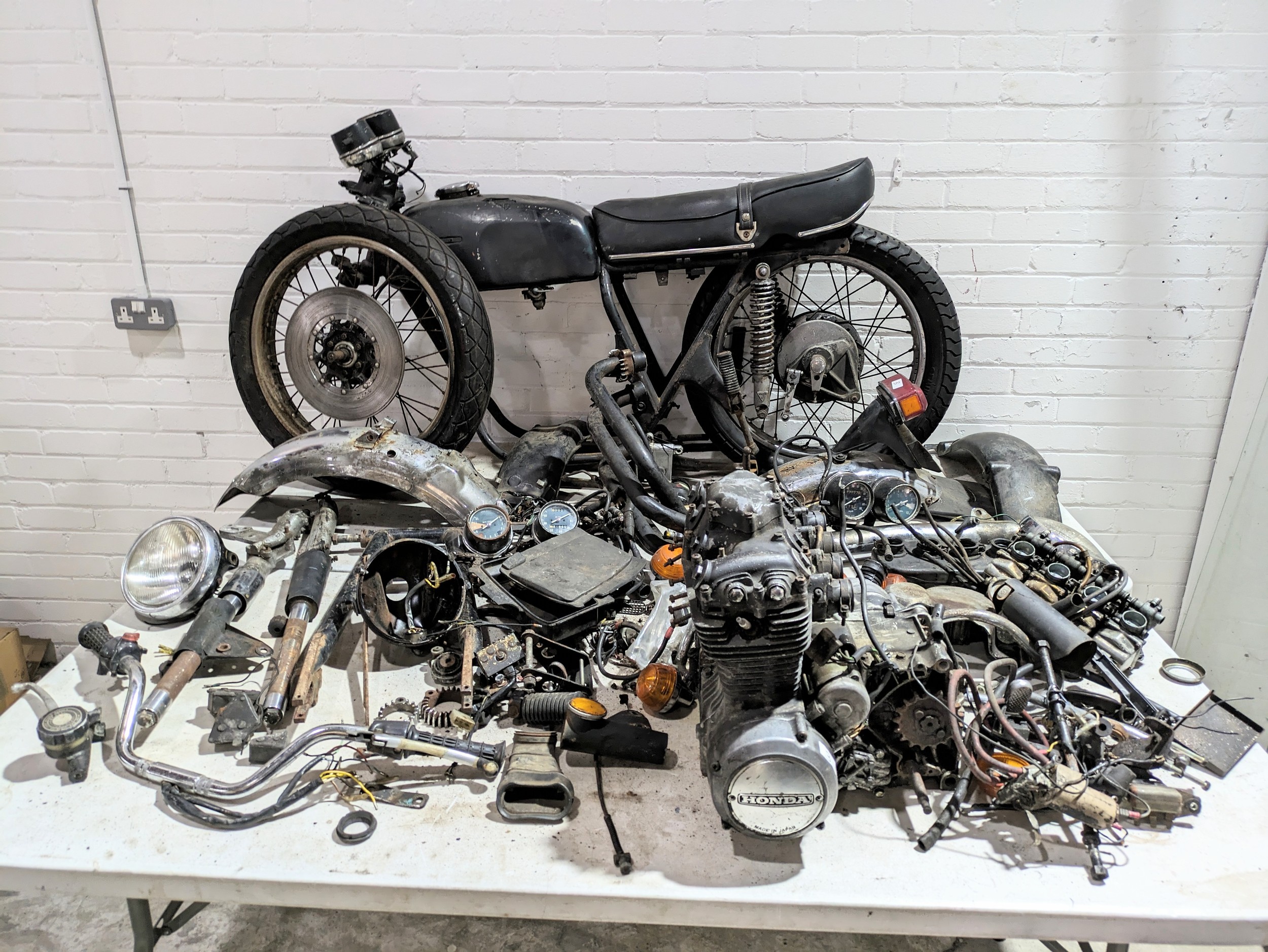 A 1979 Honda CB350-4 frame with parts and documents