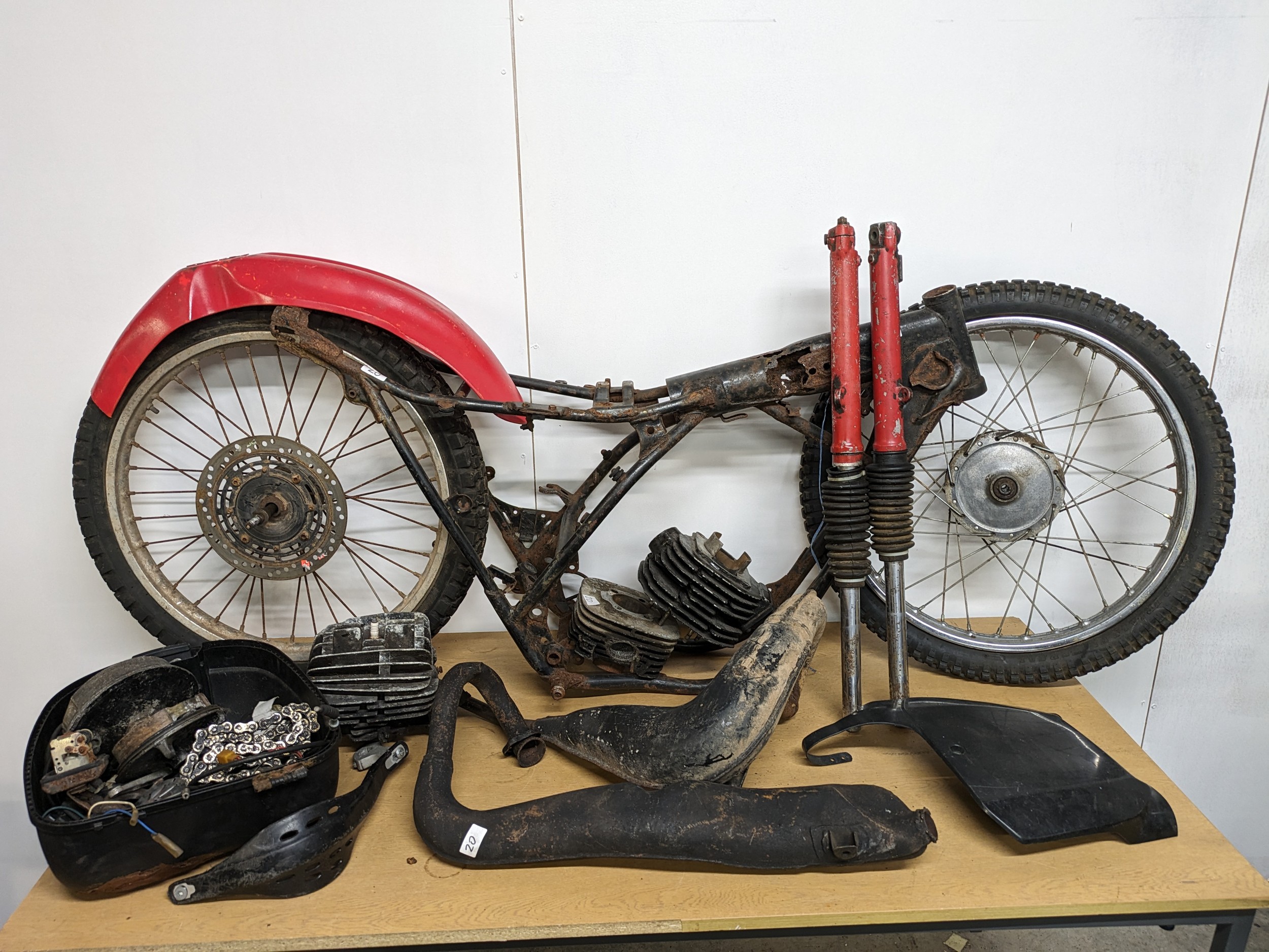 A Yamaha DT250 frame with parts and documents
