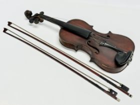 An Early 20th Century violin with bows. Named and dated 1924.