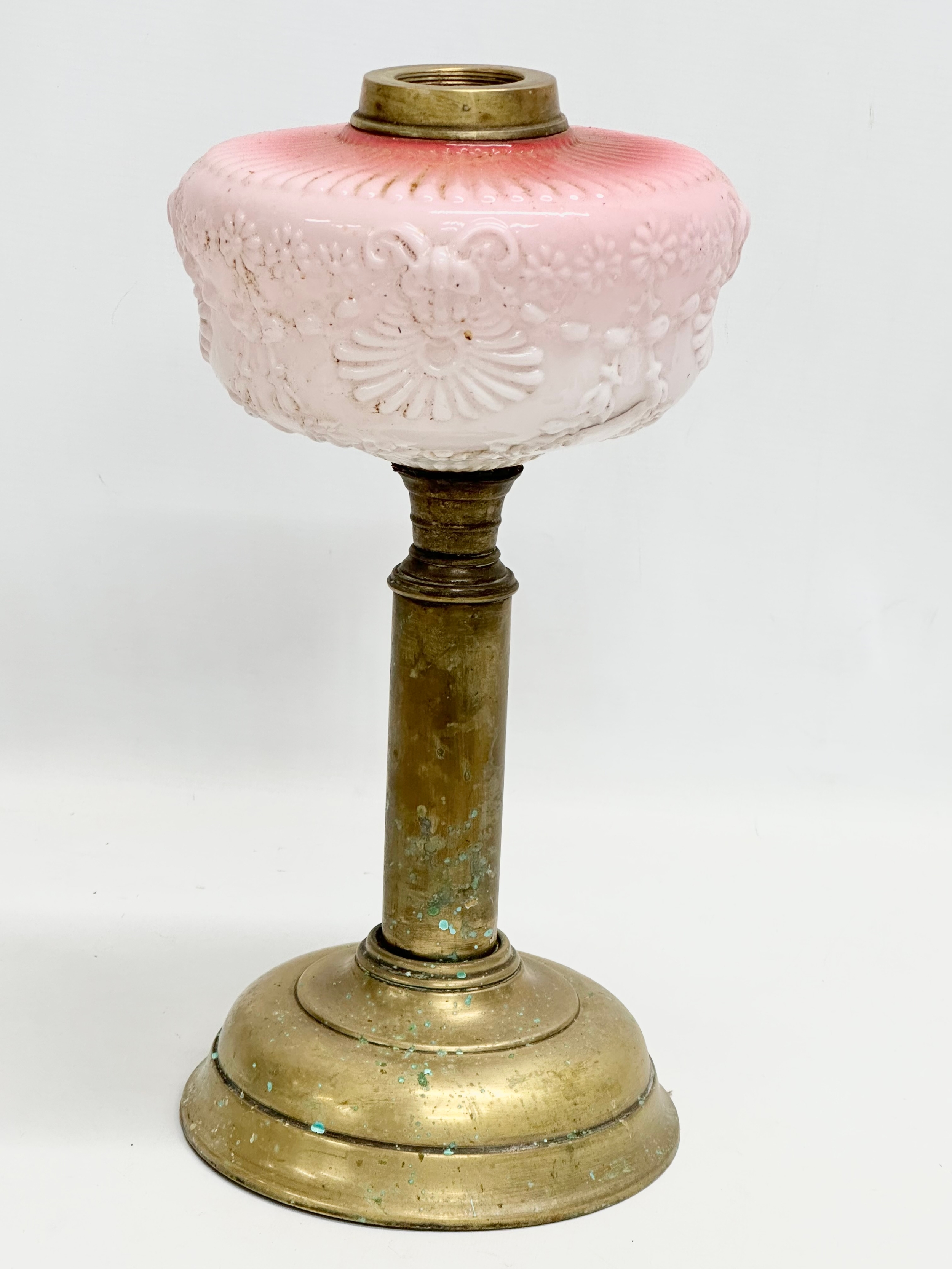 A Victorian embossed milk glass oil lamp with brass column. 35cm