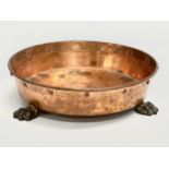 An Early 20th Century shallow copper planter with 3 brass lion paw feet. 26x7.5cm