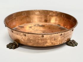 An Early 20th Century shallow copper planter with 3 brass lion paw feet. 26x7.5cm