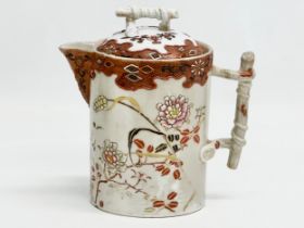 A 19th Century Japanese hand painted chocolate pot/teapot. With bamboo design handle and embossed