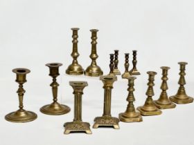 5 sets of Victorian brass candlesticks. 3 pairs and 2 sets of 4. 12cm, 11cm, 11.5. 6cm