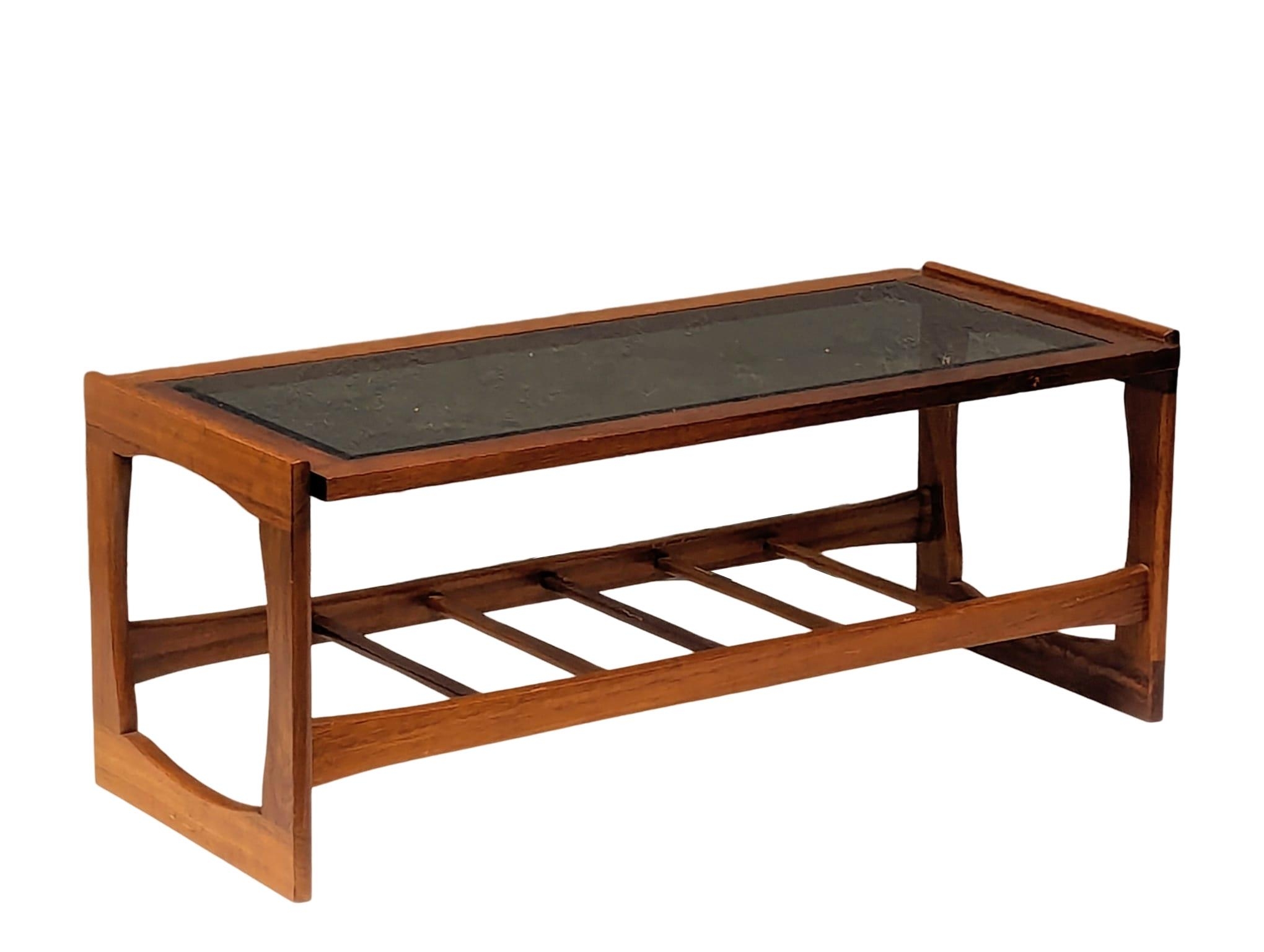A Mid Century teak and glass top coffee table. 106.5x47.5x43cm