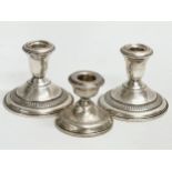 3 silver candlesticks. A pair of Sterling AMC weighted candlesticks 9.5x8cm.