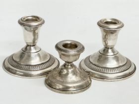 3 silver candlesticks. A pair of Sterling AMC weighted candlesticks 9.5x8cm.