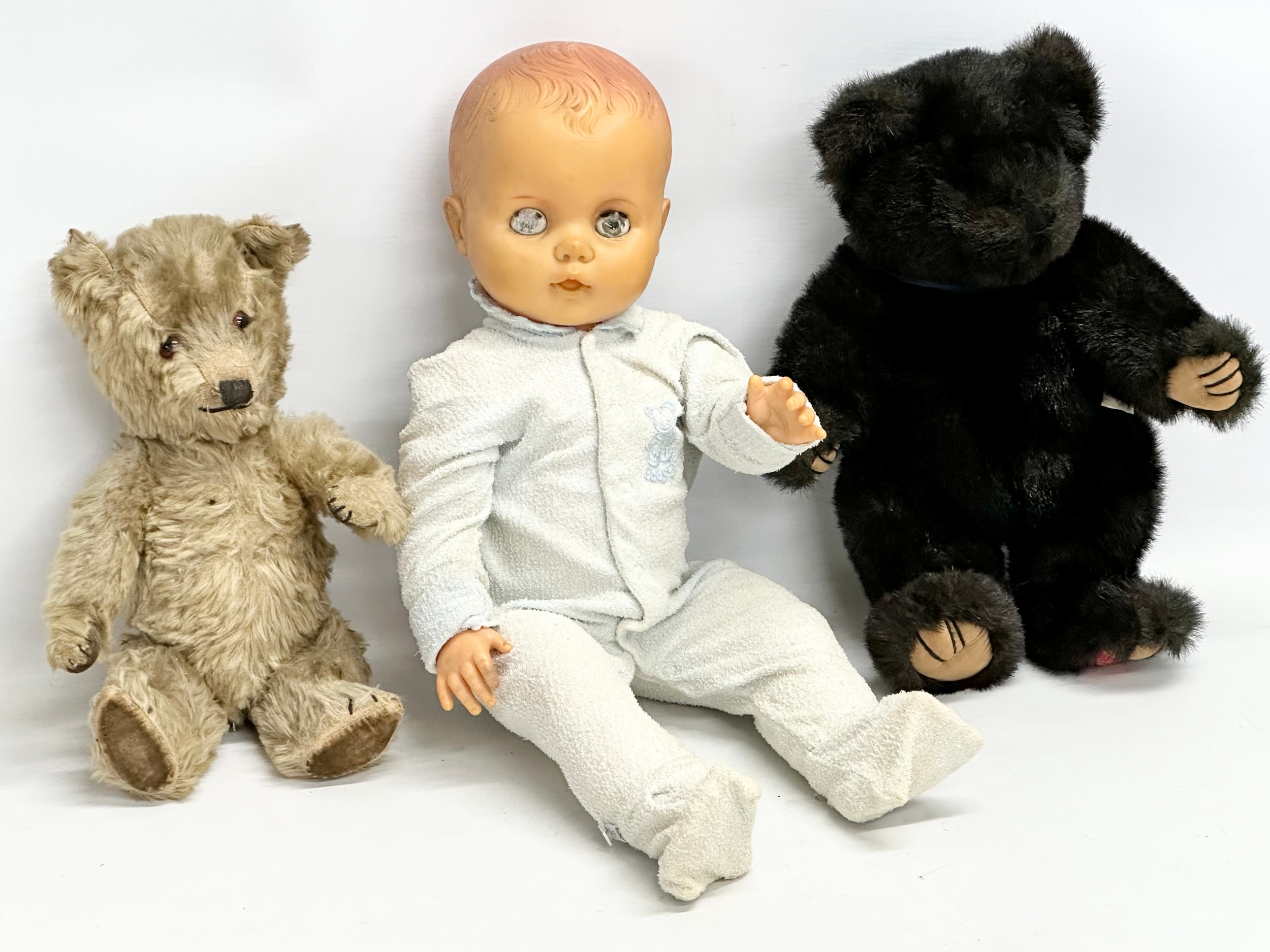 A vintage doll and teddy bears. 1 by Hamleys.