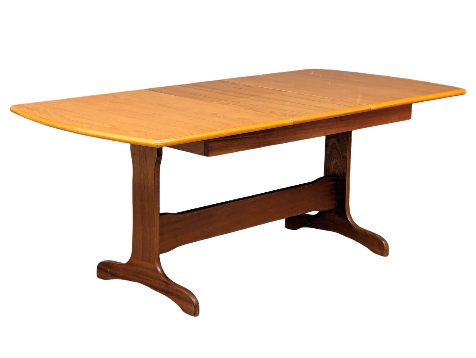 A mid century teak extending dining table, 185cm x 90cm x 73.5cm