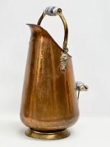 A vintage copper coal scuttle with ceramic and brass handles. 46cm
