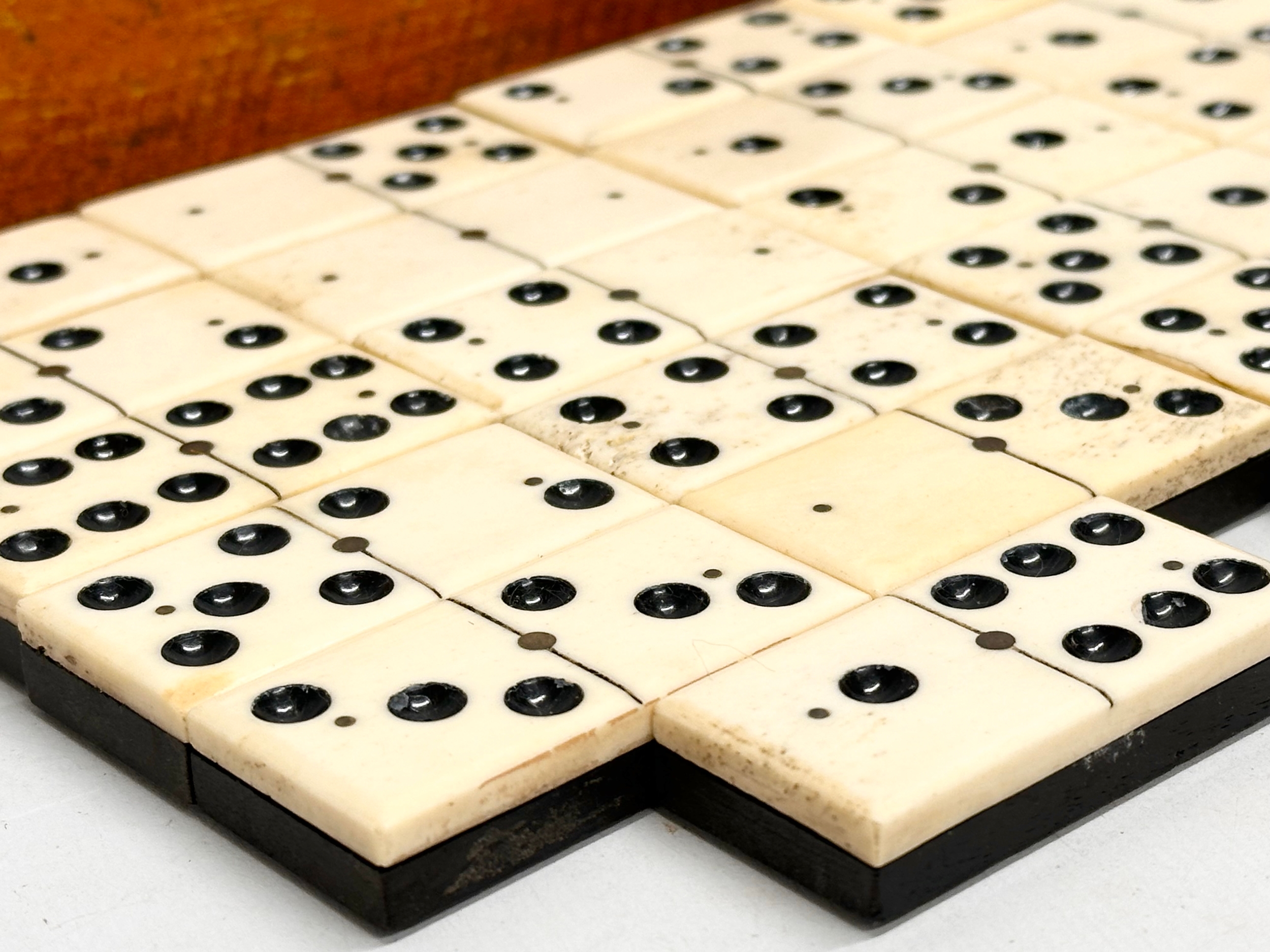 A collection of 19th Century bone and ebony dominoes with wooden box. Pieces 5.5cm. Box 21cm. - Image 2 of 6