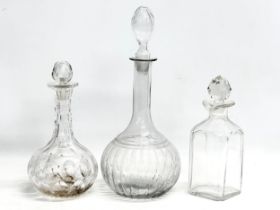 3 Mid 19th and Early 20th Century glass decanters. A large Mid 19th Century decanter 35cm.