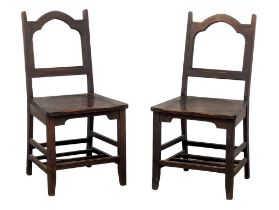 A pair of Late 19th Century Gothic Revival oak side chairs.