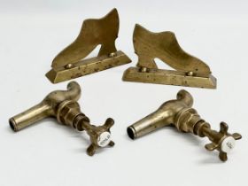 Victorian brassware. A pair of Victorian brass fireplace stands with a pair of Victorian brass taps.