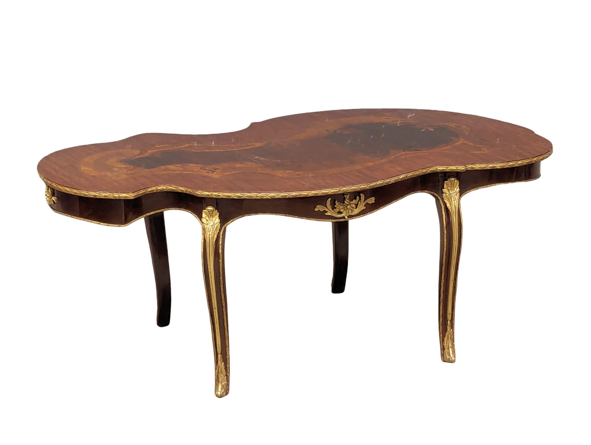 An Italian inlaid coffee table with brass mounts. 115x67x46cm