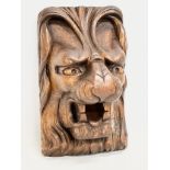 A 19th Century carved lion mask wall plaque. 14x24cm