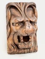 A 19th Century carved lion mask wall plaque. 14x24cm