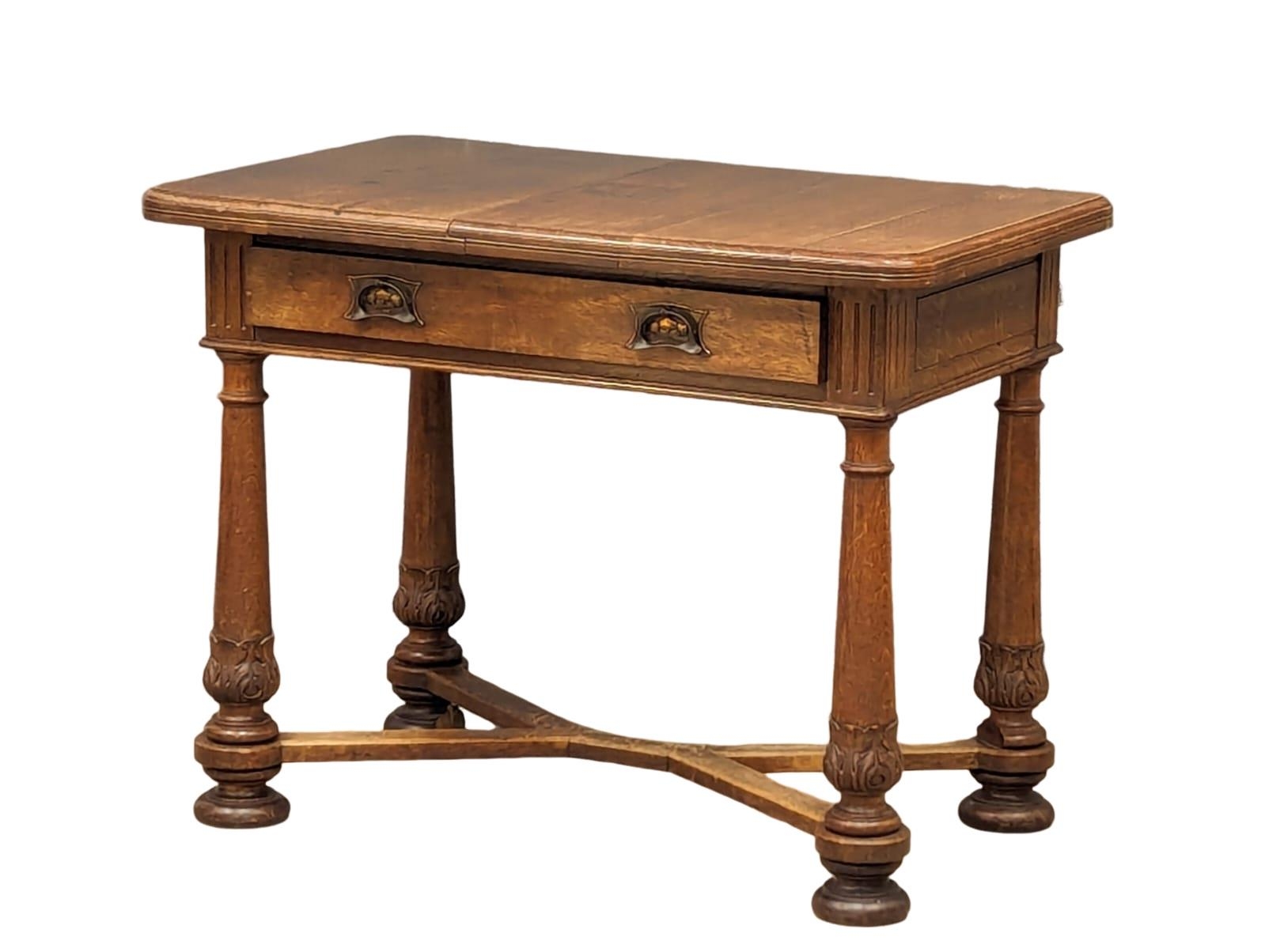 A Late 19th Century oak side table with drawer as copper Art Nouveau handles. 98x65x76cm