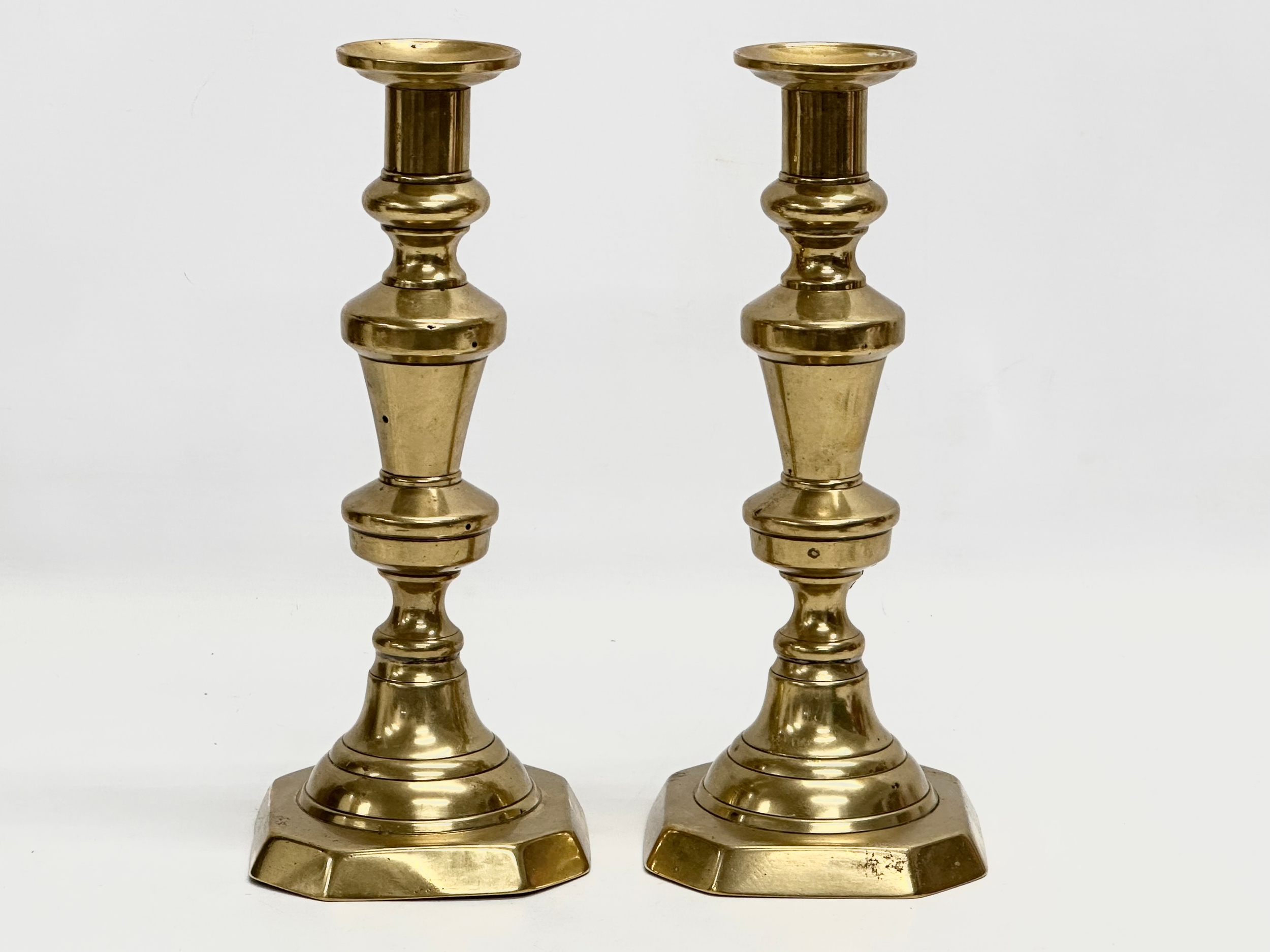 A pair of large Victorian brass candlesticks. 27cm