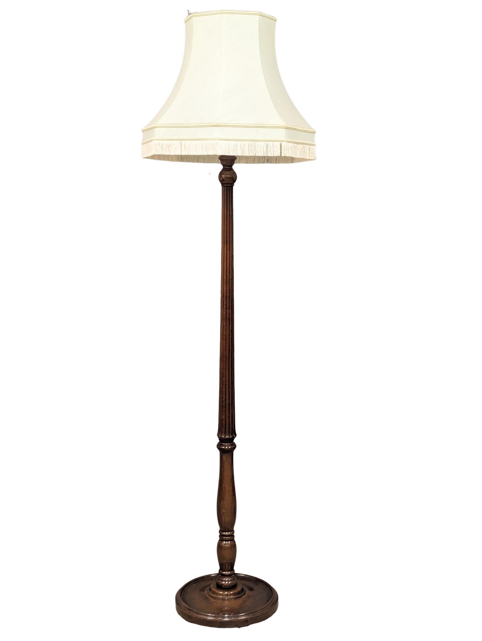 A mahogany standard lamp with reeded column. 197cm