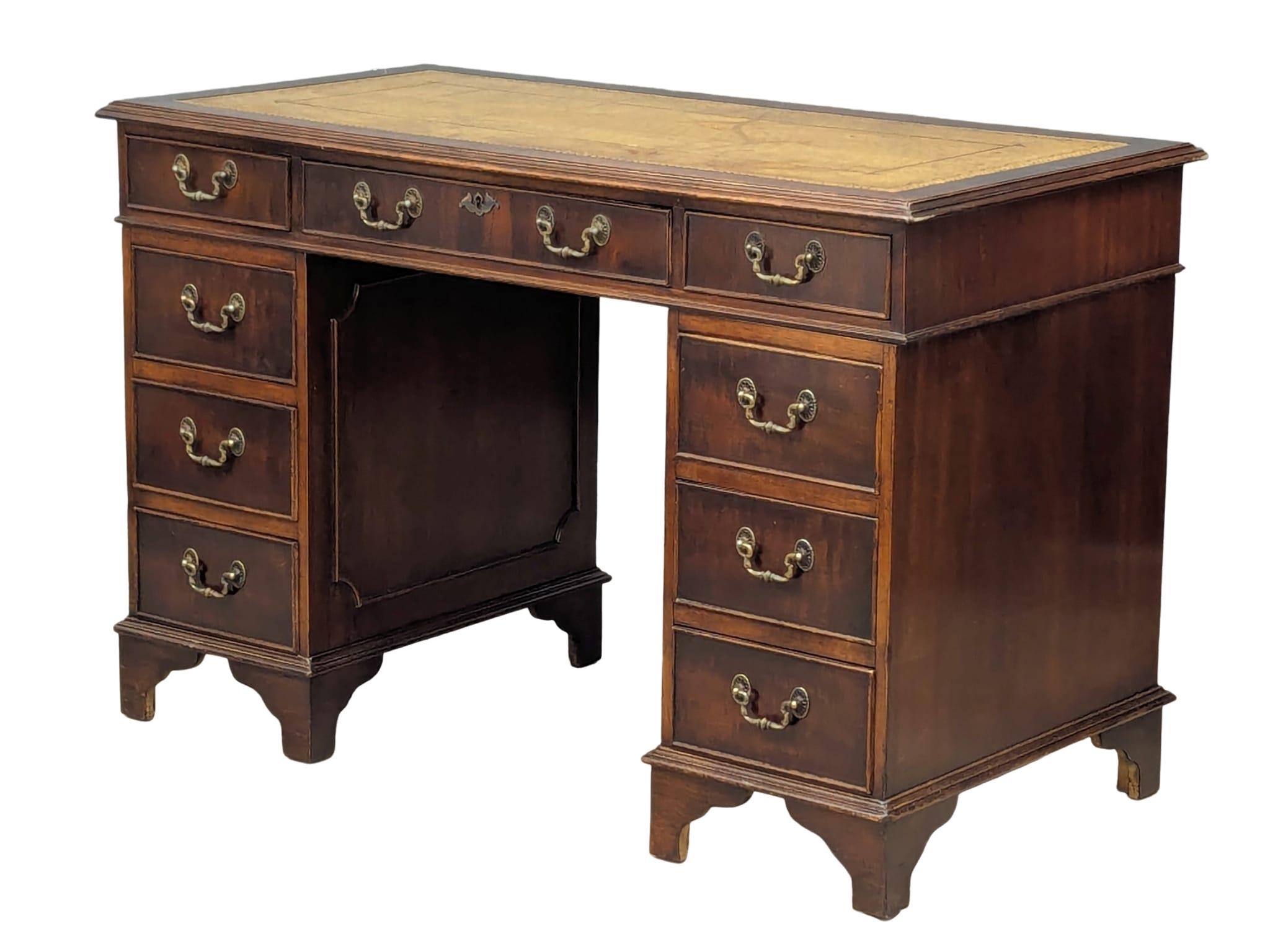 A George III style mahogany leather top desk, 118cm x 60cm x 77cm