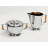 An Art Deco chromium plated sugar bowl and matching milk jug.