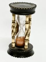 A Late 19th Century bone and ebony hourglass. 9.5cm