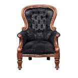 A Victorian style spoon back armchair.