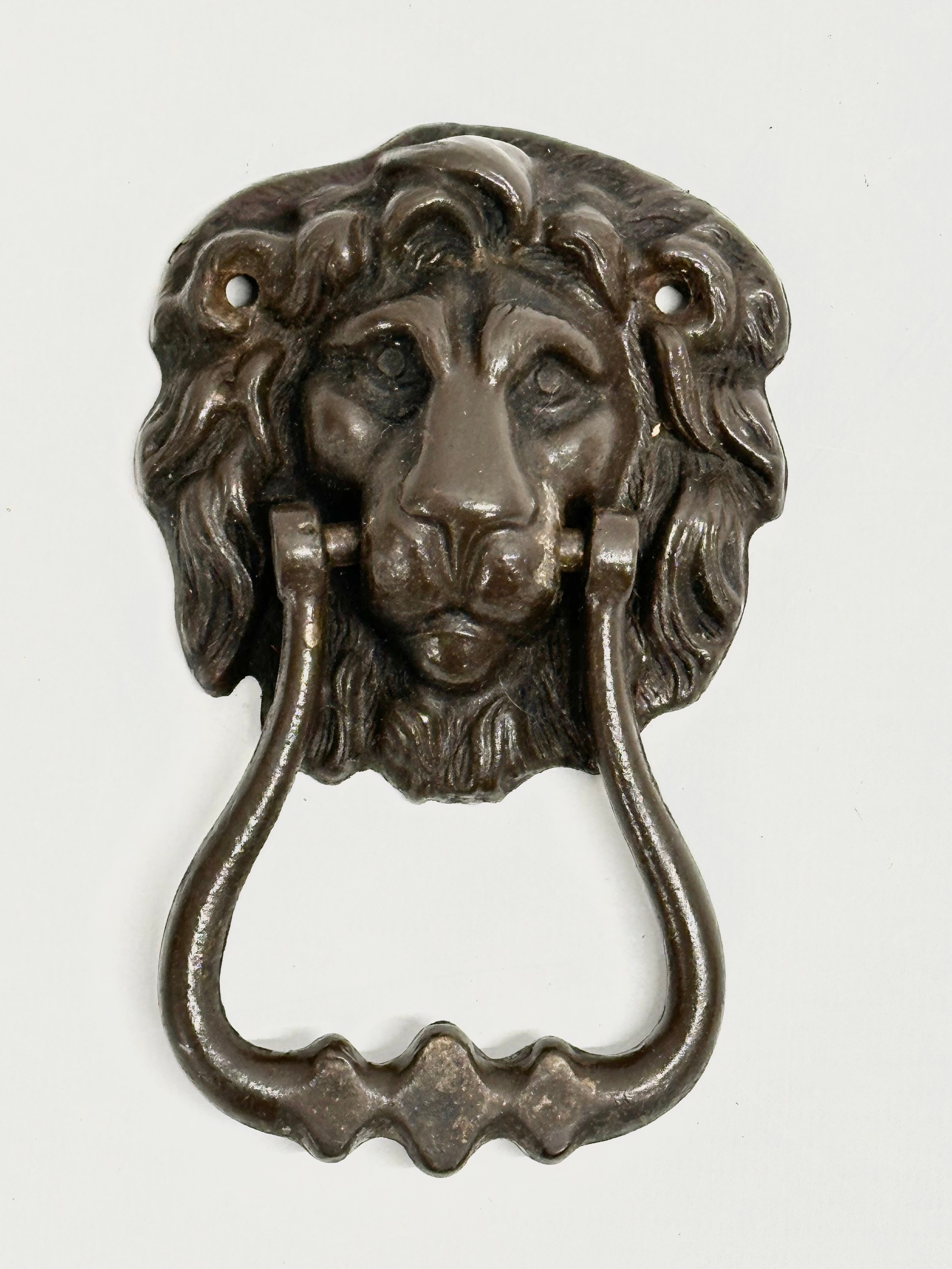 A Victorian bronze door knocker. 8x13cm