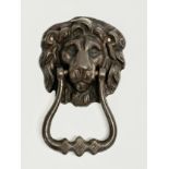 A Victorian bronze door knocker. 8x13cm