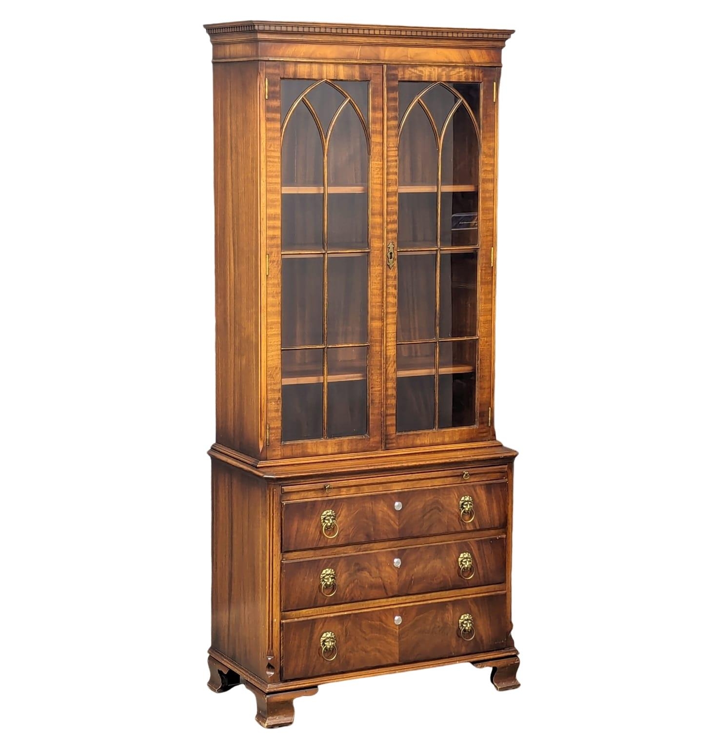 A Georgian style mahogany bookcase with brushing slide and astragal glazed doors. 75x40x176.5cm