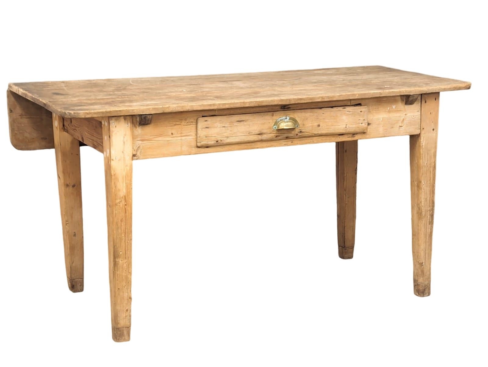 A 19th Century pine farmhouse table on square tapering legs with drawer and 1 drop-leaf, Circa