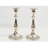 A pair of silver plated candlesticks. 28cm