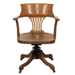 An Early 20th Century oak swivel desk chair. Circa 1900.