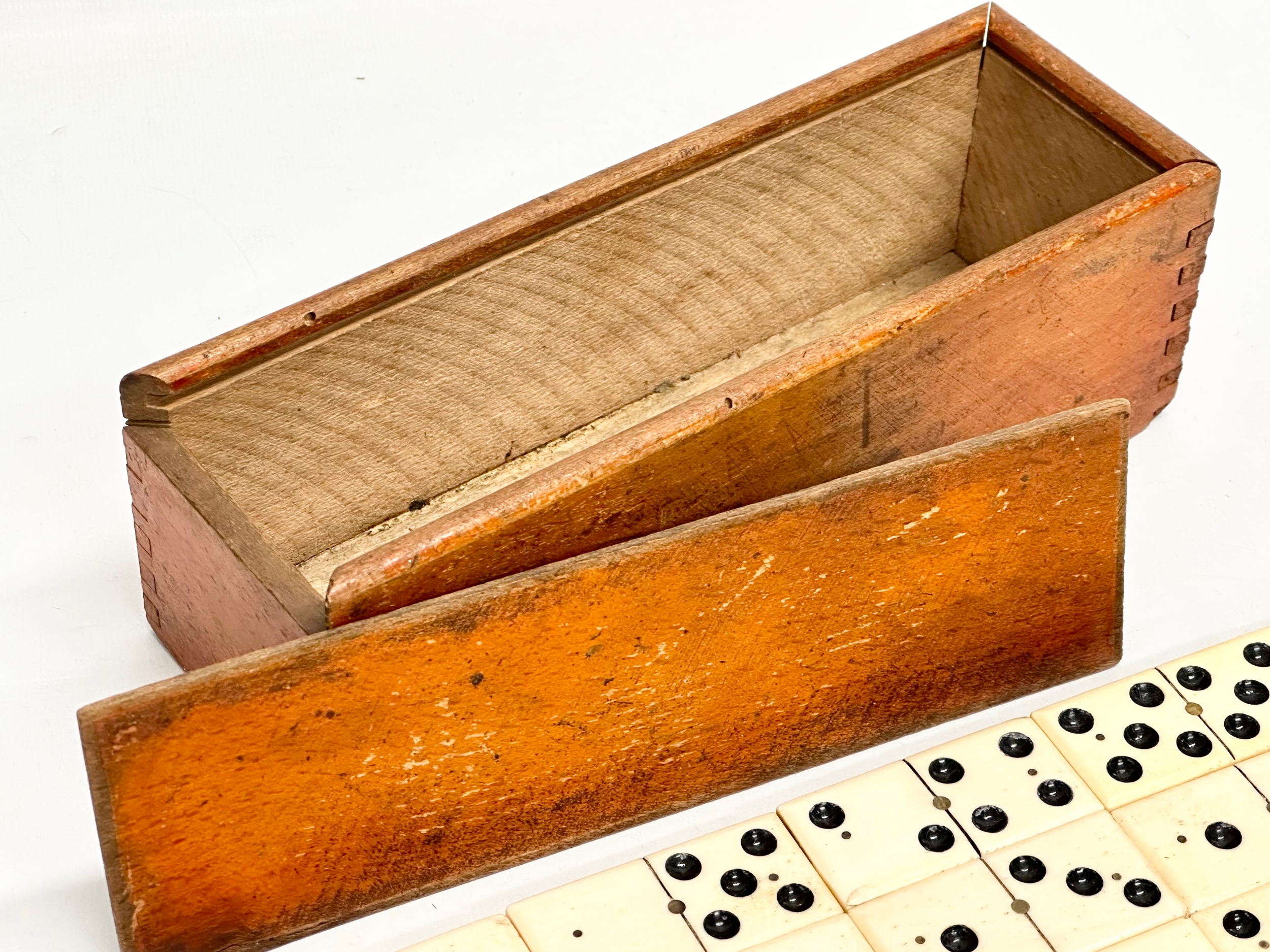 A collection of 19th Century bone and ebony dominoes with wooden box. Pieces 5.5cm. Box 21cm. - Image 6 of 6