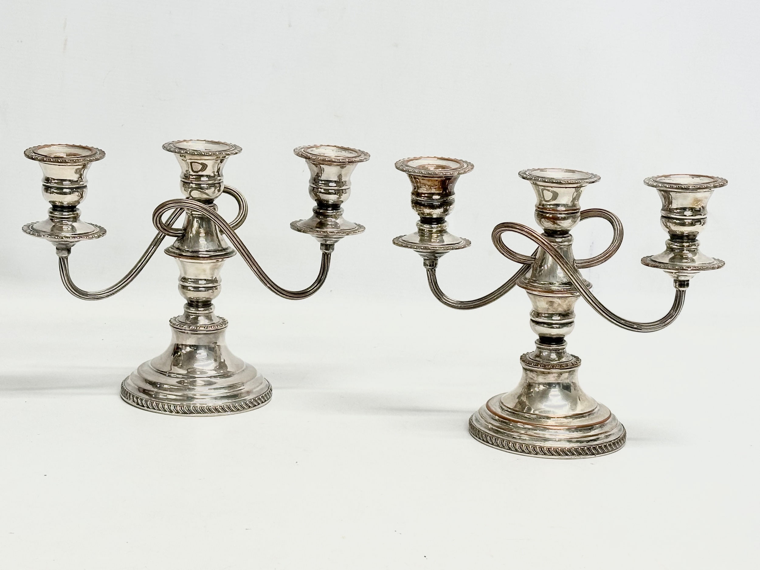 A pair of good quality Edwardian silver plated candelabras. 24x19.5cm