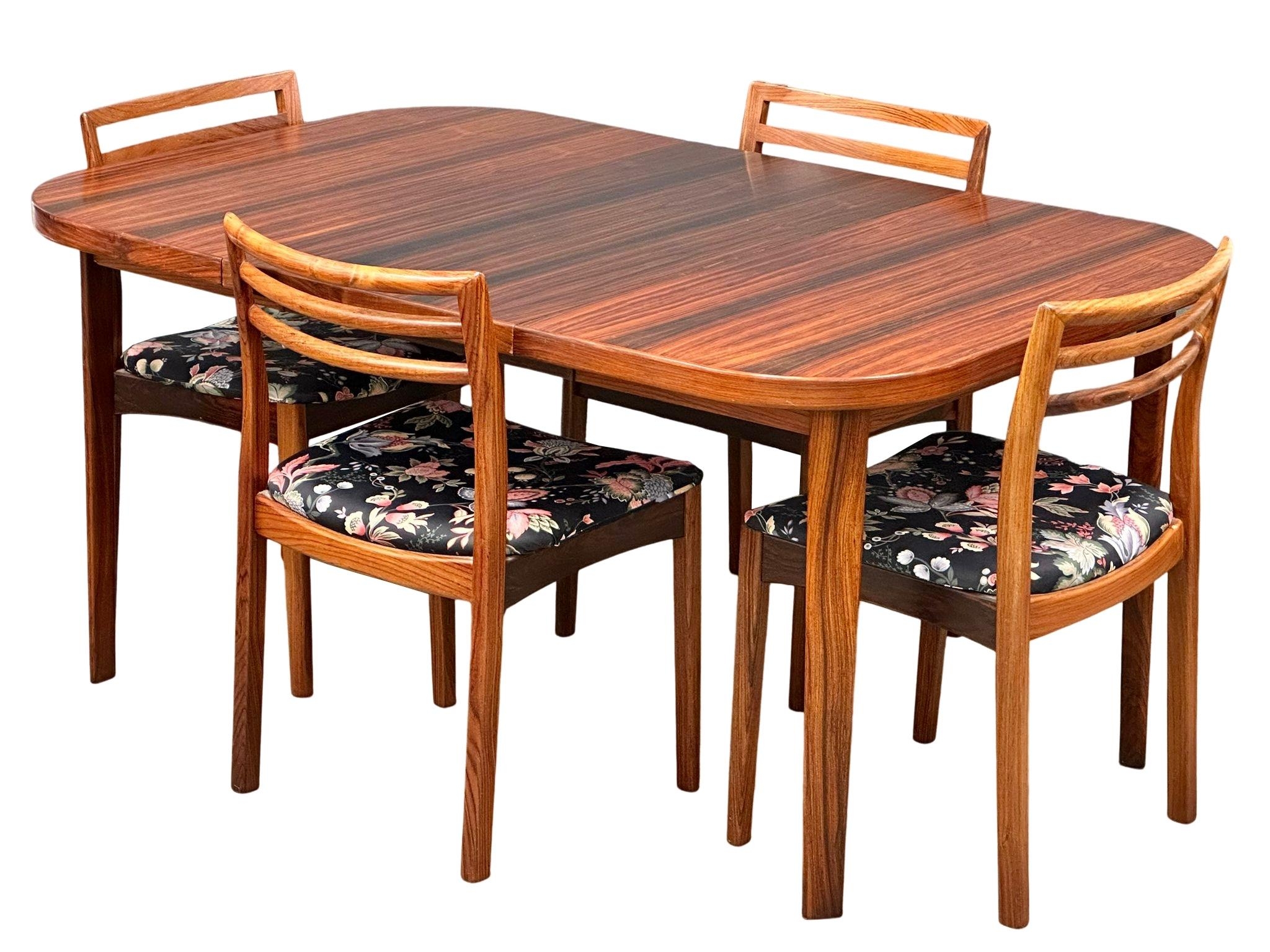 A Danish Mid Century rosewood extending dining table and 4 chairs. Closed 101x101x73cm. 1 leaf