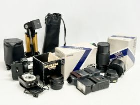 A collection of camera equipment. Yashica lens, flash etc. Subagor camera stand and other. Super